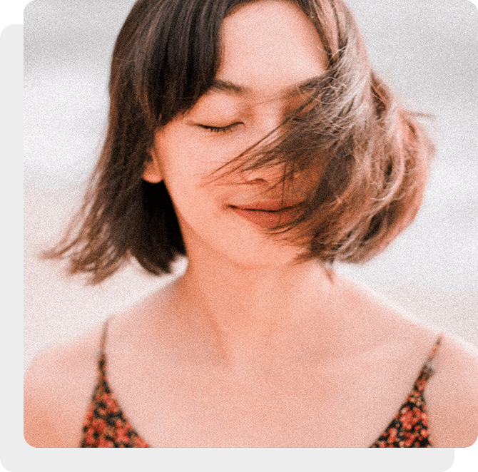 A woman with her hair blowing in the wind.