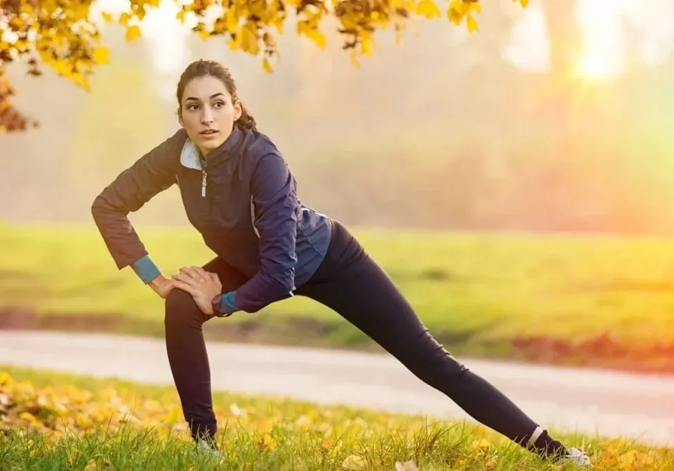 Athletic woman performing side lunge stretch