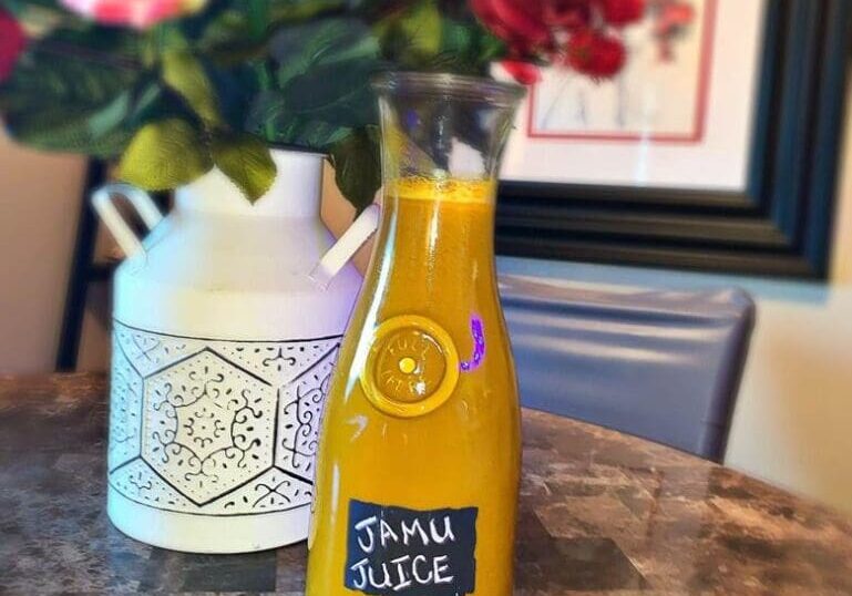 A bottle of juice sitting on top of a table.